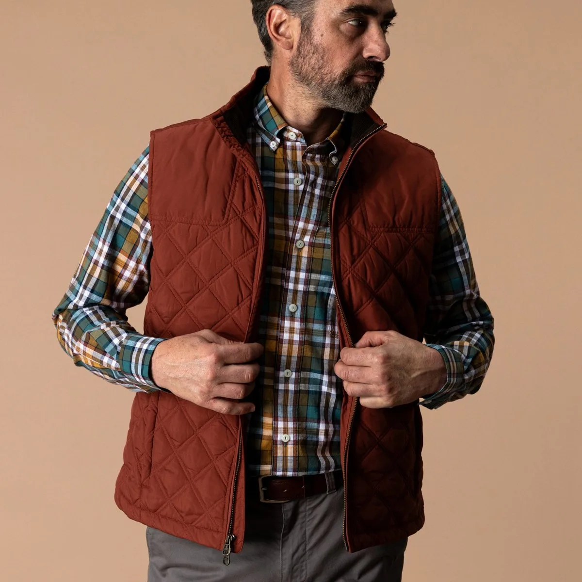 Duck Head Fremont quilted vest in Brandy Brown worn over a plaid shirt