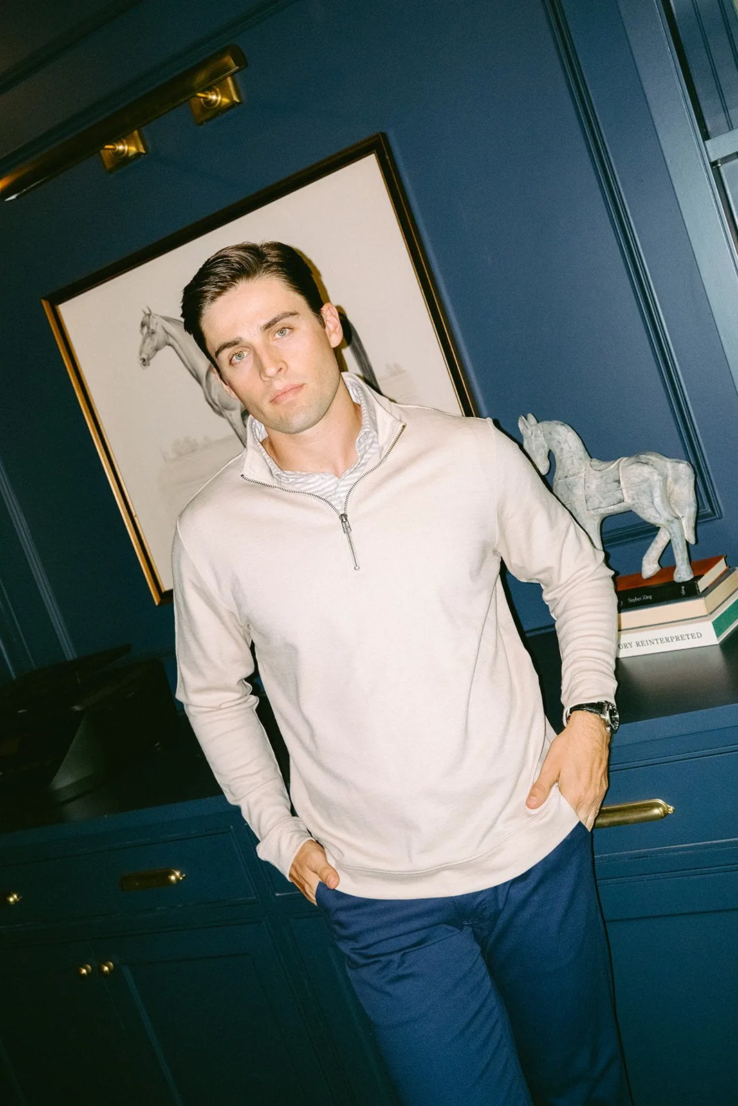 Olydoe Merino Ponte Quarter Zip in Sand worn in a wood-paneled study